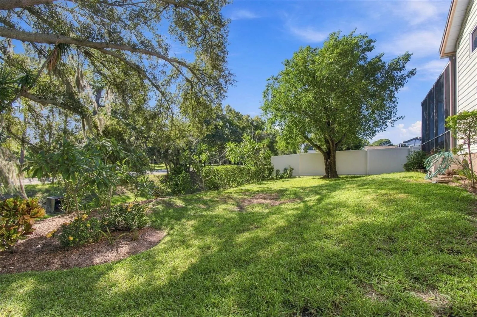 Peaceful backyard with trees and mature landscaping