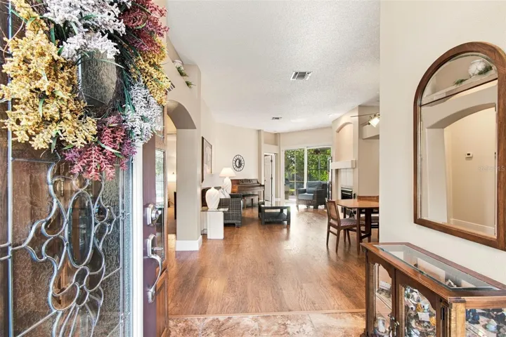 Welcome! View from Foyer to Living Room and Dining.  Hurricane sliders to lanai.