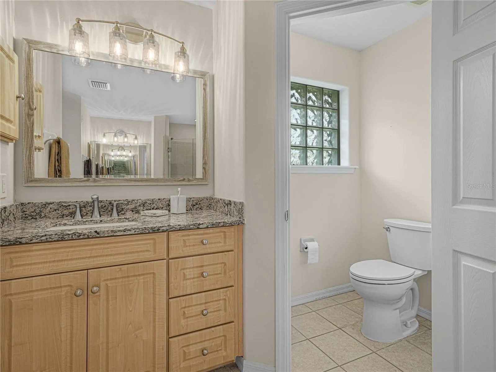 Primary bathroom has dual vanities and a separate water closet