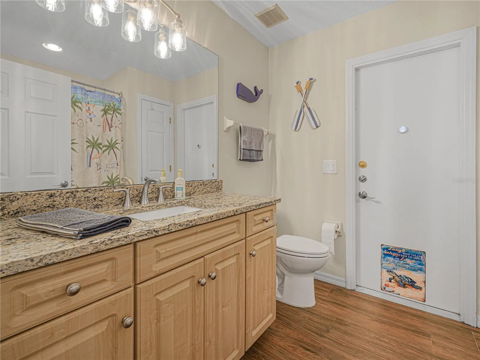 Hall bathroom leads to pool and has granite counters