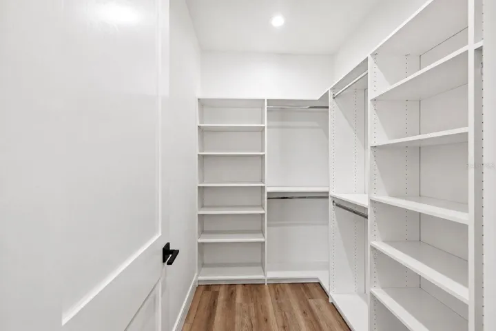 Primary bedroom walk-in closet