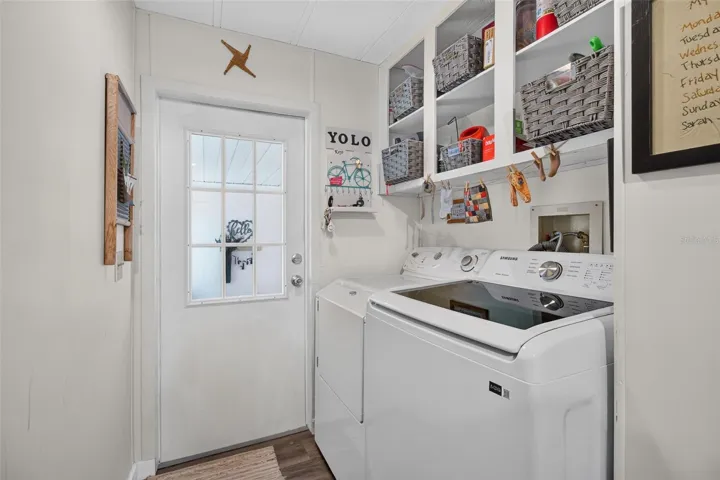 Interior laundry with door to front room, entry.