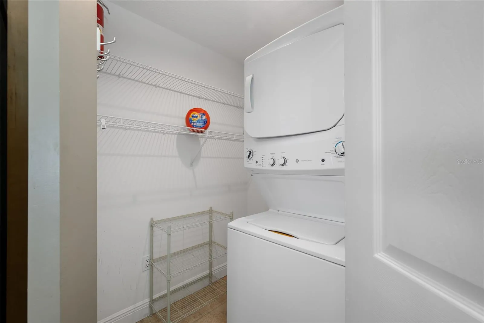 Laundry/Storage Room with Stack Washer and Dryer.