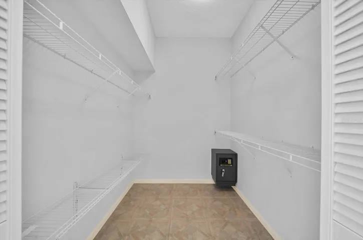 Primary bedroom walk-in closet