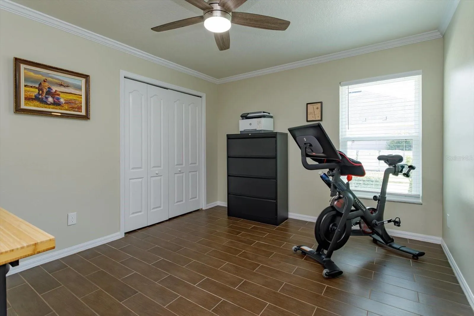 Freshly painted bedroom 3 features new fan, new blinds and wood look tile floors