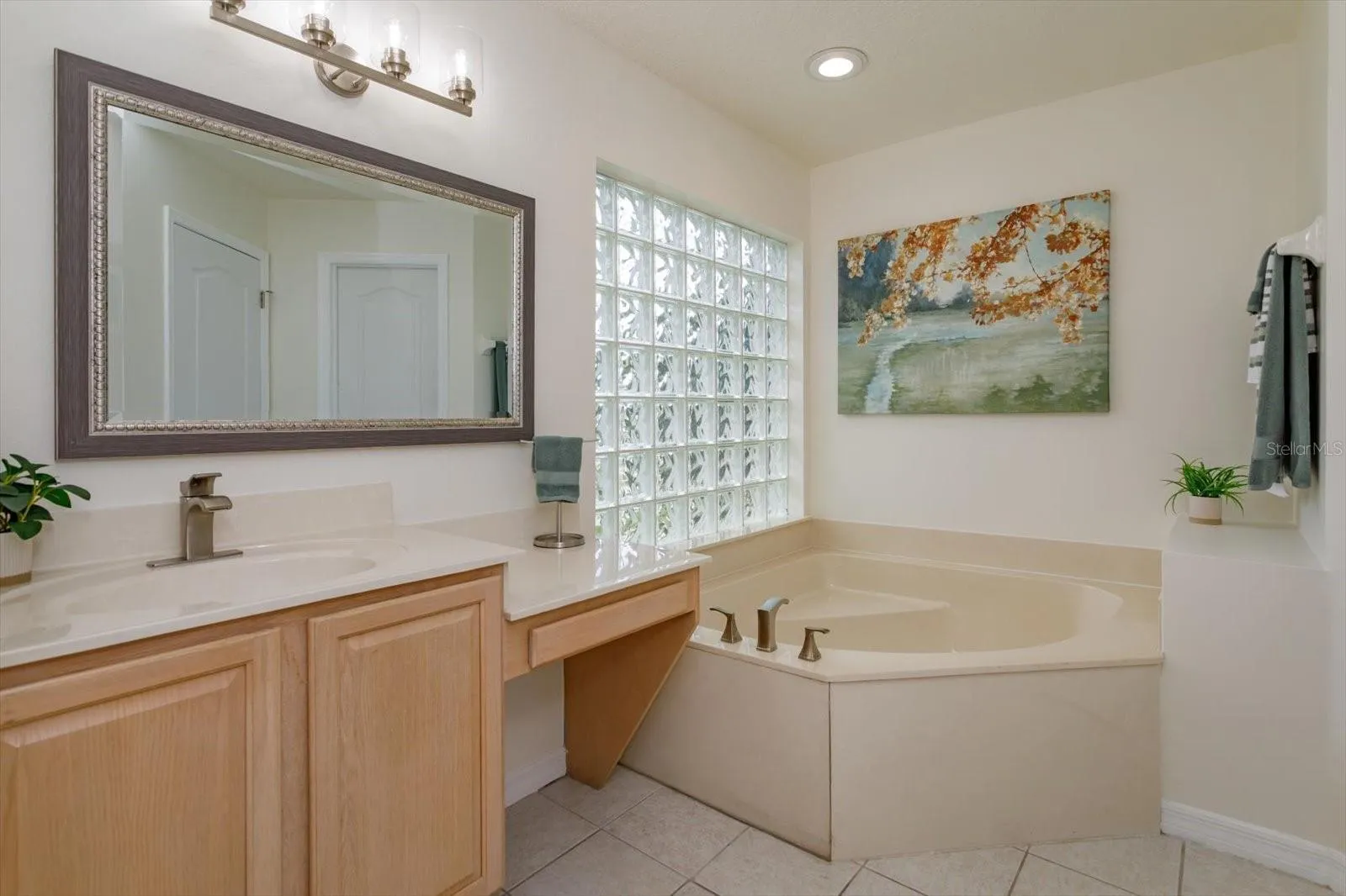 Her primary bathroom features corner tub, knee space and private water closet