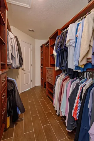 Custom walk in closet with floor safe in the primary suite