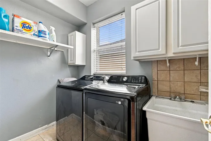 Your laundry room is bright and cheerful with a window and laundry sink.