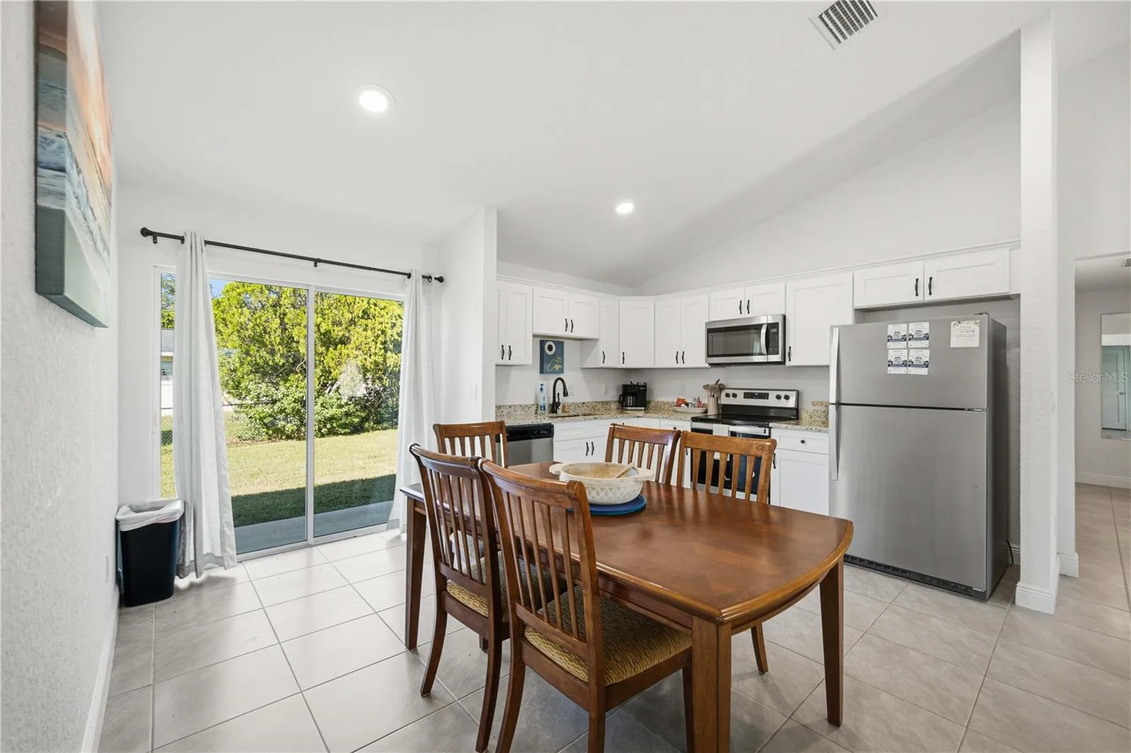 L - Shaped Kitchen with Sliders to the Backyard