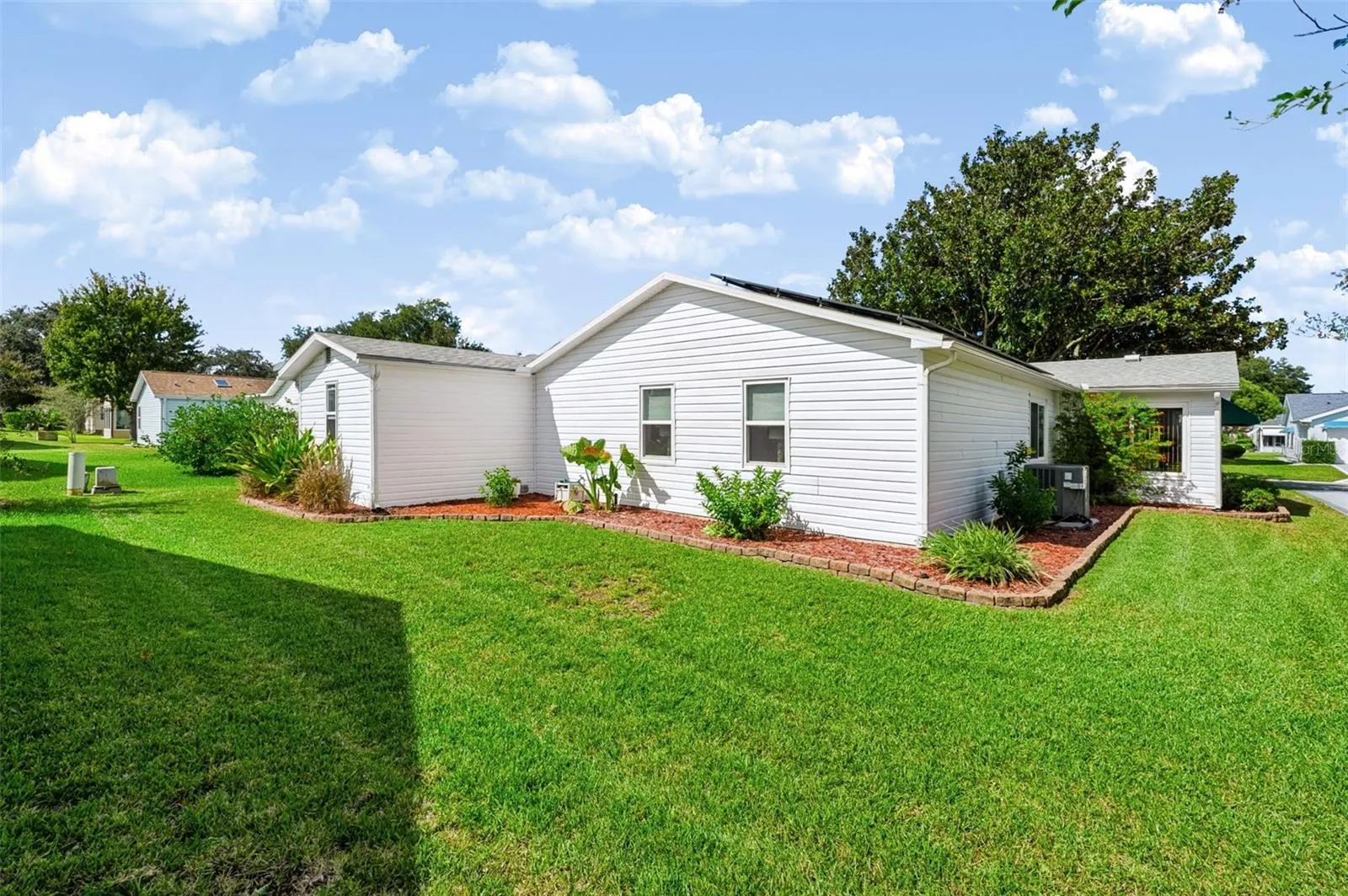 Backside of home with landscaping