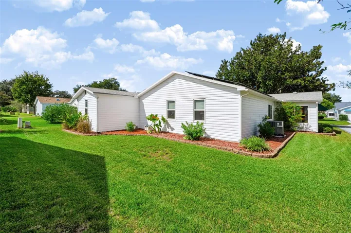 Backside of home with landscaping