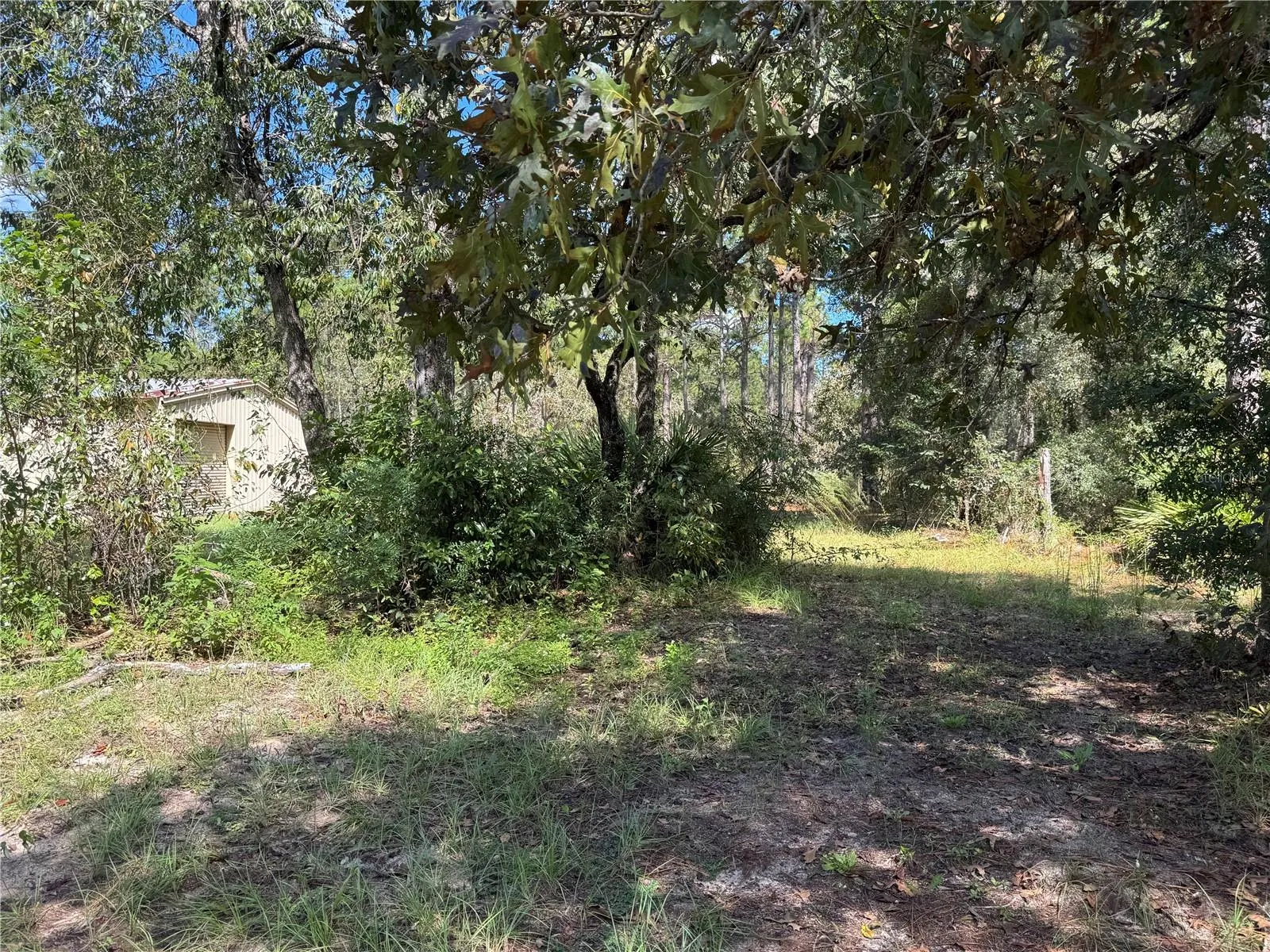 CENTER REAR (EASTERN BACK BOUNDARY) ALONG REAR BOUNDARY TO 2615 SW 157TH CT HOME WITH WORKSHOP. BOTH PROPERTIES CAN BE SOLD TOGETHER OR SEPARATE