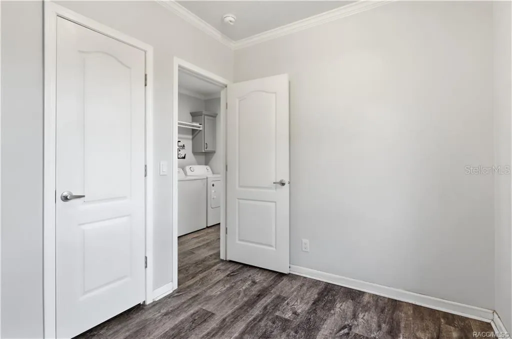 FLEXIBILITY FOR YOUR LIFESTYLE! Another view of this room highlights the attractive flooring, natural light &amp; convenient access to the indoor laundry area.