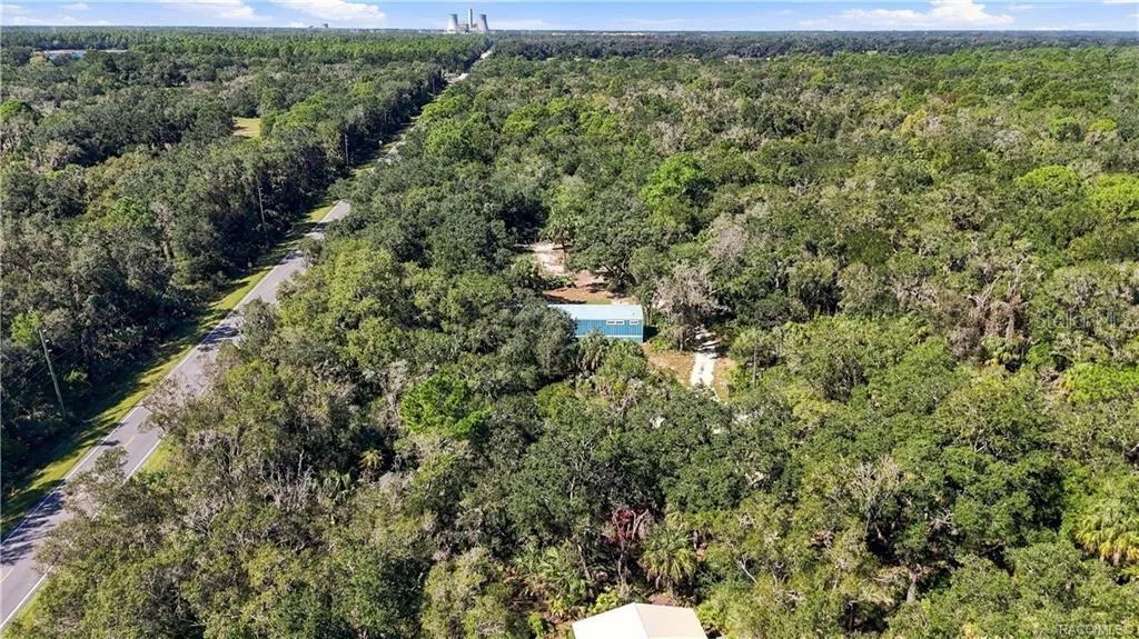 SURROUNDED BY NATURE! This expansive aerial view captures the home tucked among beautiful trees &amp; the wooded character of the surrounding area.
