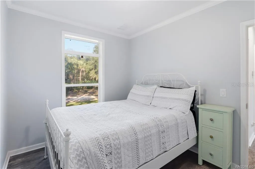 A PEACEFUL PLACE TO UNWIND! This inviting BEDROOM features soft neutral colors, attractive flooring, crown molding &amp; a large window overlooking the beautiful natural surroundings.