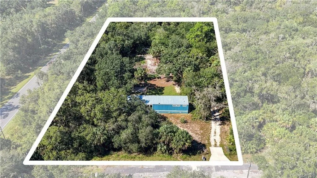 AERIAL PROPERTY VIEW: A beautiful look at the 1.42 FULLY FENCED ACRES w/GATED ENTRANCE, surrounded by mature trees, Florida palms &amp; natural greenery. Room to enjoy the outdoors!