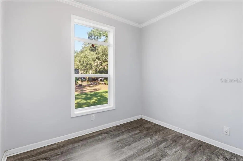 A ROOM TO MAKE YOUR OWN! This additional room features LUXURY VINYL PLANK FLOORING, crown molding, neutral colors &amp; a window overlooking the greenery.