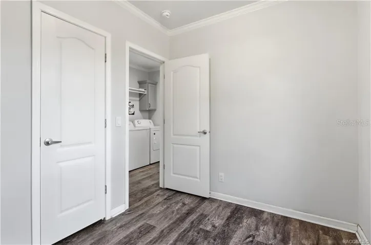 FLEXIBILITY FOR YOUR LIFESTYLE! Another view of this room highlights the attractive flooring, natural light &amp; convenient access to the indoor laundry area.