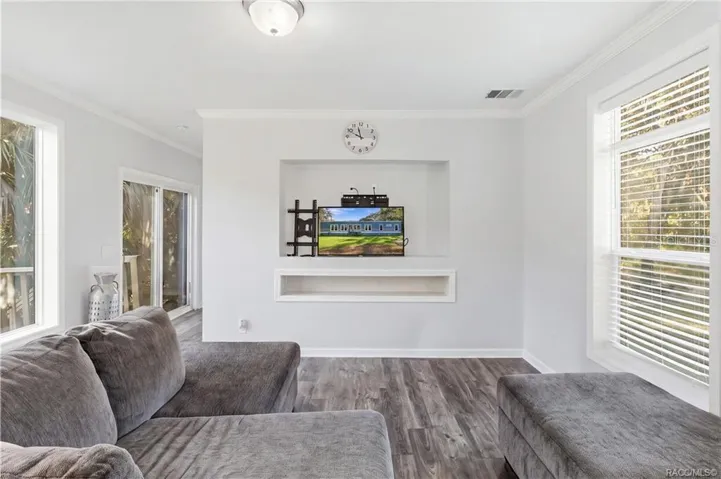 A COZY PLACE TO UNWIND! Enjoy the comfortable living area featuring large windows, neutral finishes &amp; a recessed entertainment space.