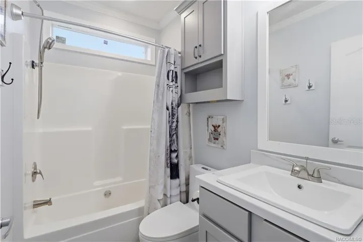 STYLE &amp; EVERYDAY CONVENIENCE! The SECOND FULL BATHROOM features a GRAY VANITY, framed mirror, additional wall cabinetry &amp; a TUB/SHOWER COMBINATION.