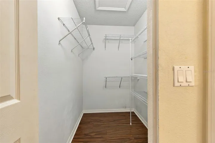 Primary bedroom walk-in closet