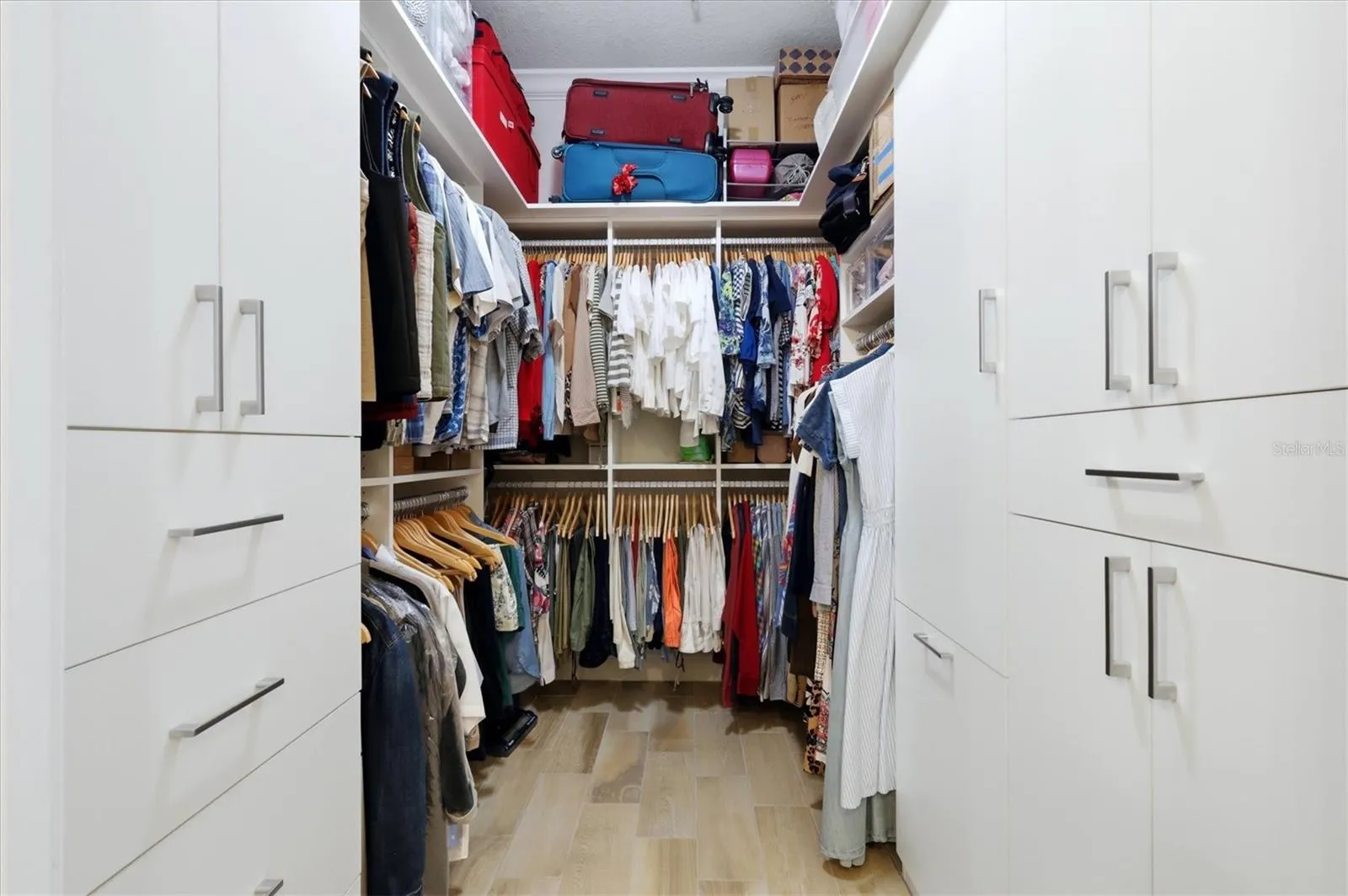 Primary walk-in closet with custom built-ins