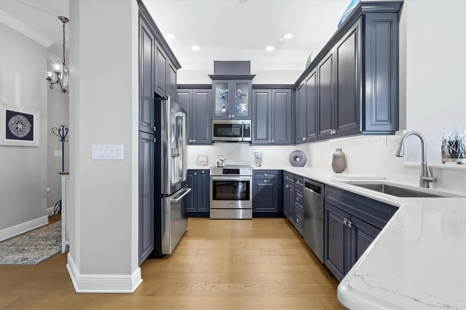 Kitchen has custom cabinetry, quartz countertops.