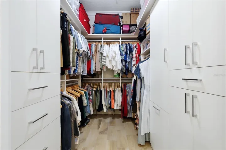 Primary walk-in closet with custom built-ins