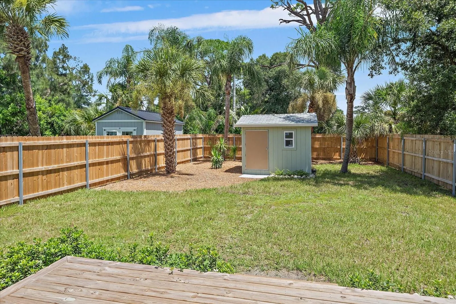 Backyard with deck off the primary bedroom &amp; shed with electric