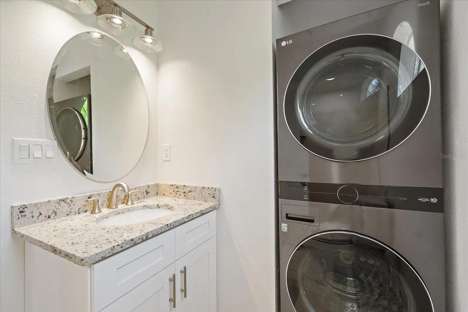 Bathroom with stackable washer &amp; dryer &amp; walk-in shower