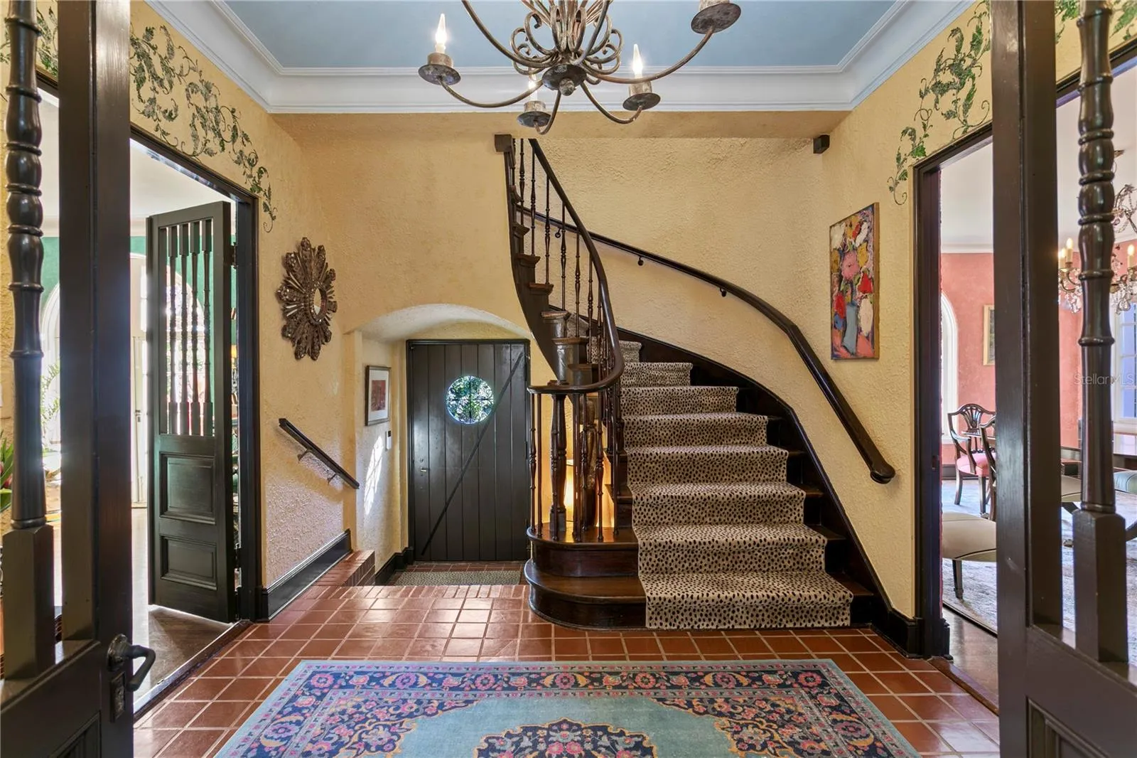 Foyer looking towards the front door flanked by the Living Room on the left and the Dining Room to the right. Nine foot ceilings in both levels.