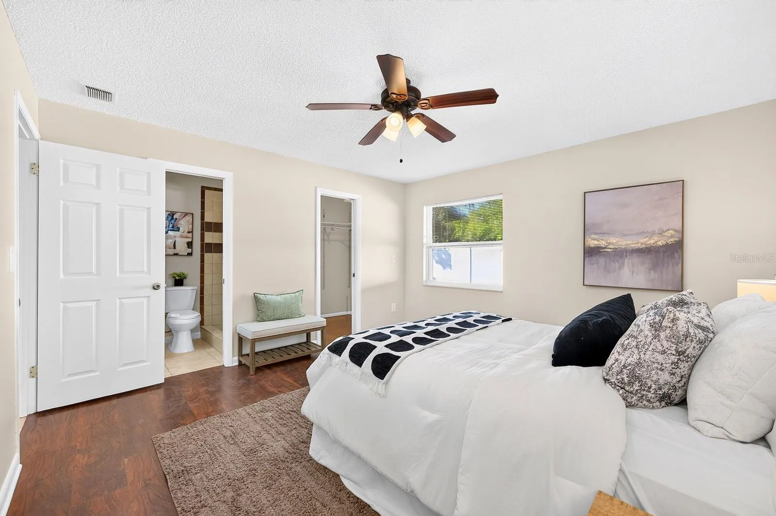 The Primary Suite offers laminate flooring, a WALK-IN CLOSET and private en suite Bath.