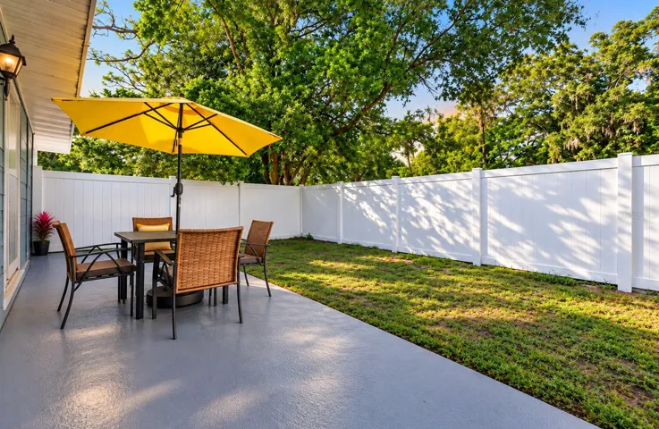 Sliding glass doors open to a SIDE PATIO, offering a lovely spot to enjoy your morning coffee or relax outdoors.
