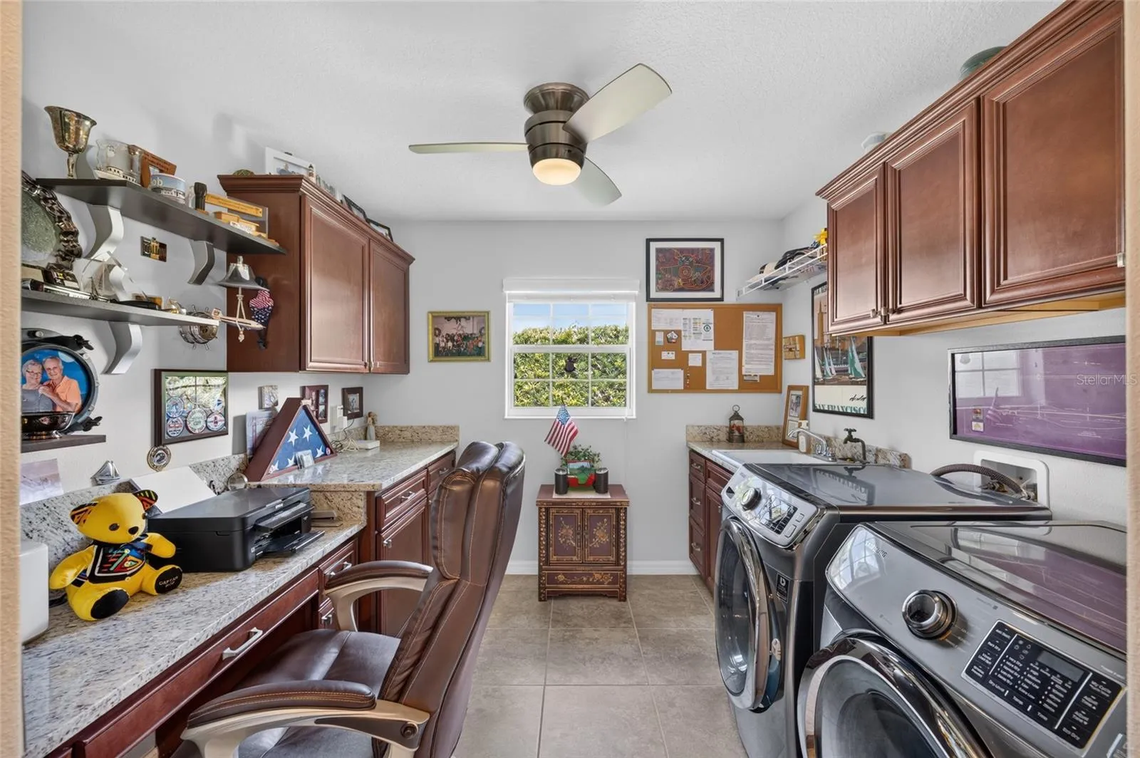 Laundry with sink, cabinets and built-in desk.