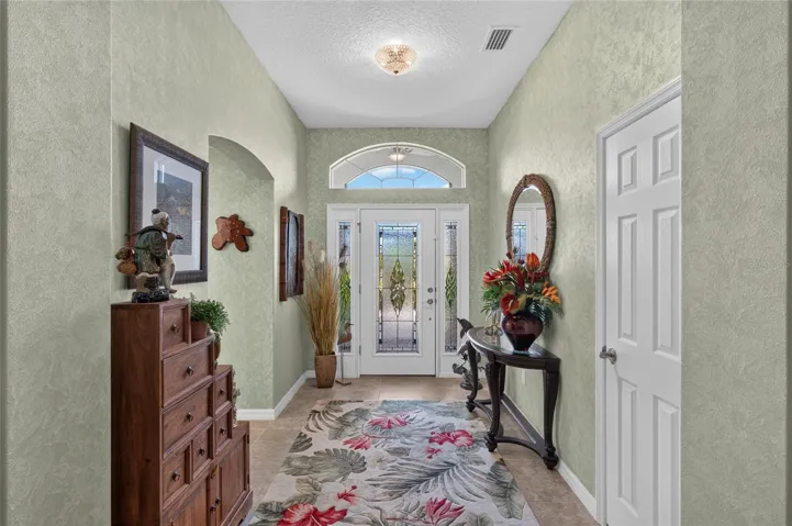 LEADED GLASS FRONT DOOR WITH DOUBLE SIDE LIGHTS AND TRANSOM WINDOWS.