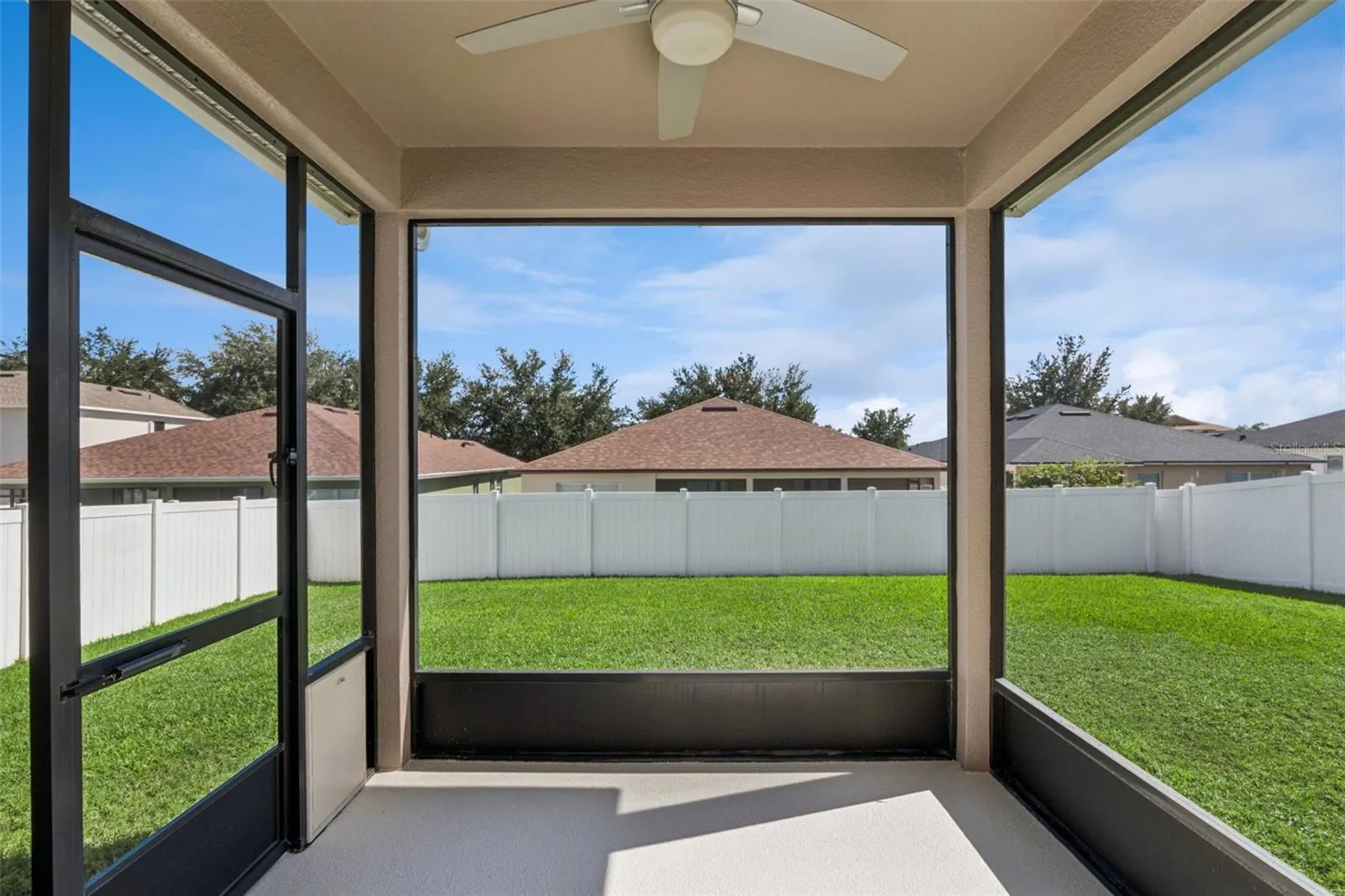 Screened enclosed patio overlooking spacious fenced backyard