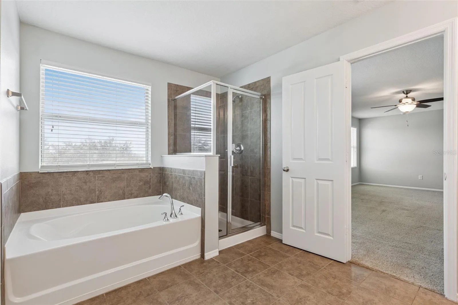 Primary ensuite bathroom featuring large garden tub