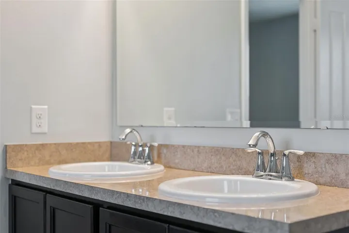 Primary ensuite bathroom with dual sinks