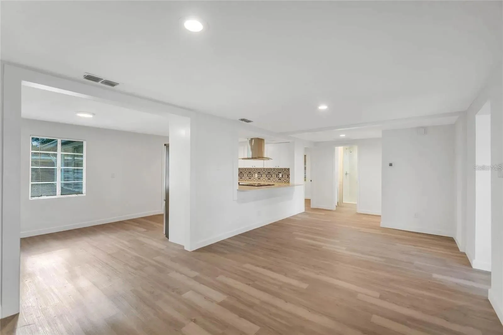 Photo of living room, dining area and kitchen prior to furniture.