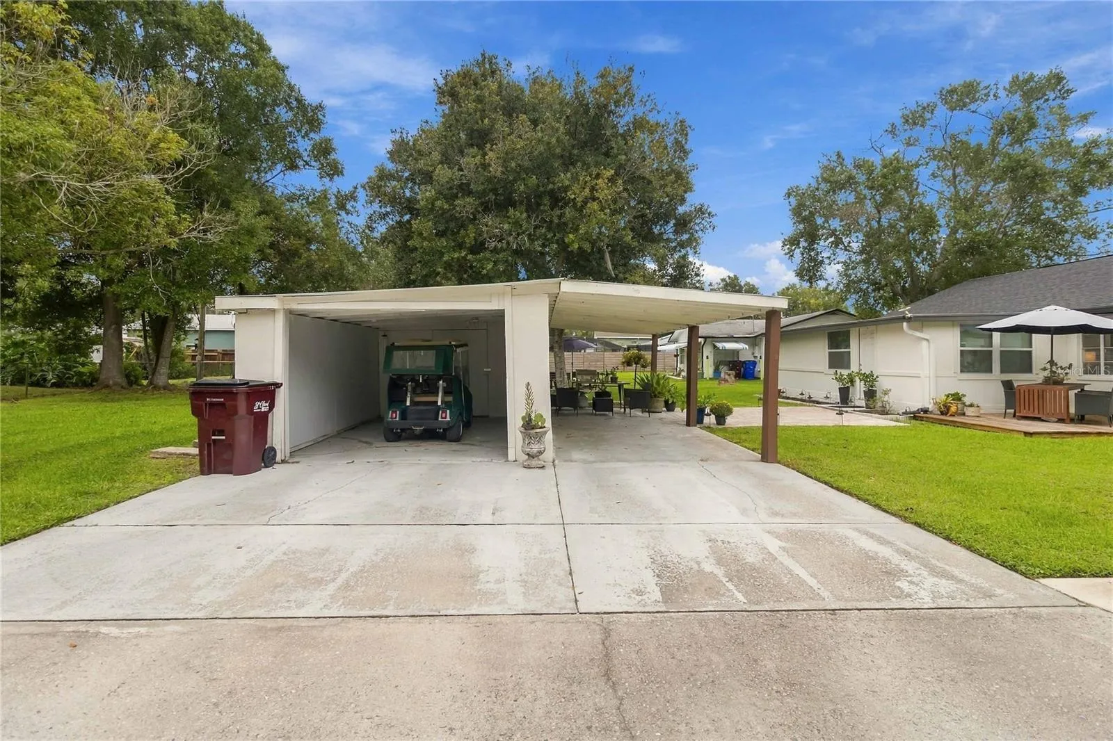 Detached garage with extra storage and a carport.