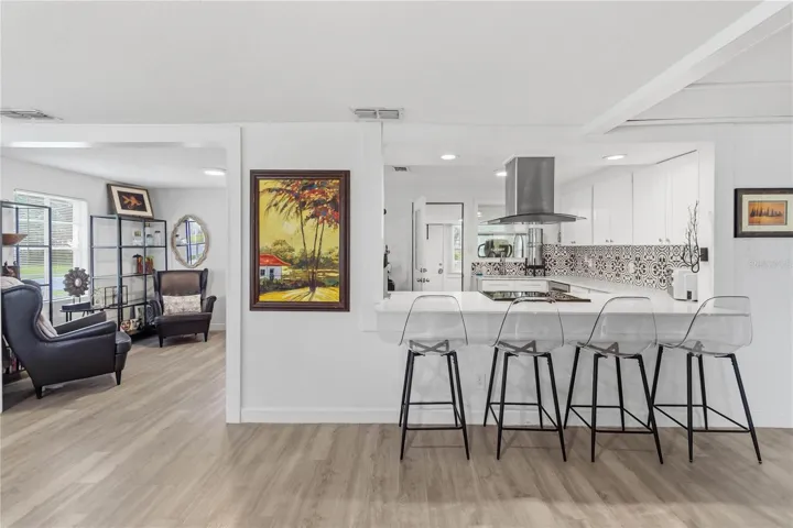 Kitchen with large breakfast bar and cozy seating area that could be used as a dining room.