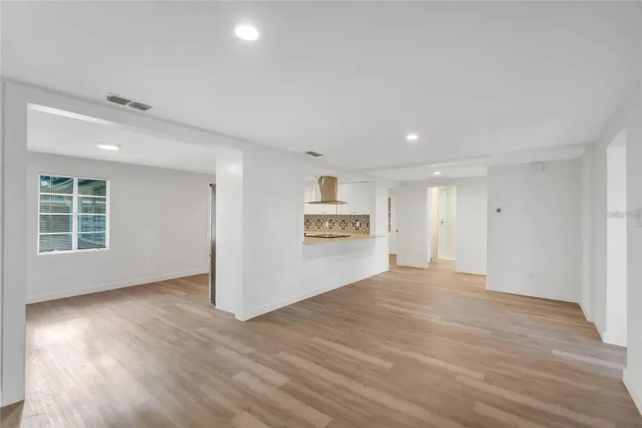 Photo of living room, dining area and kitchen prior to furniture.