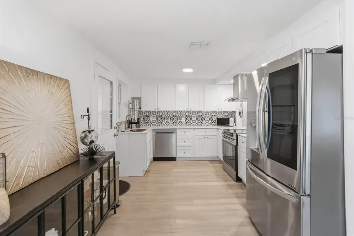 The stunning kitchen with quartz counters and stainless steel appliances including an induction stove with convection oven that is 3 months old.