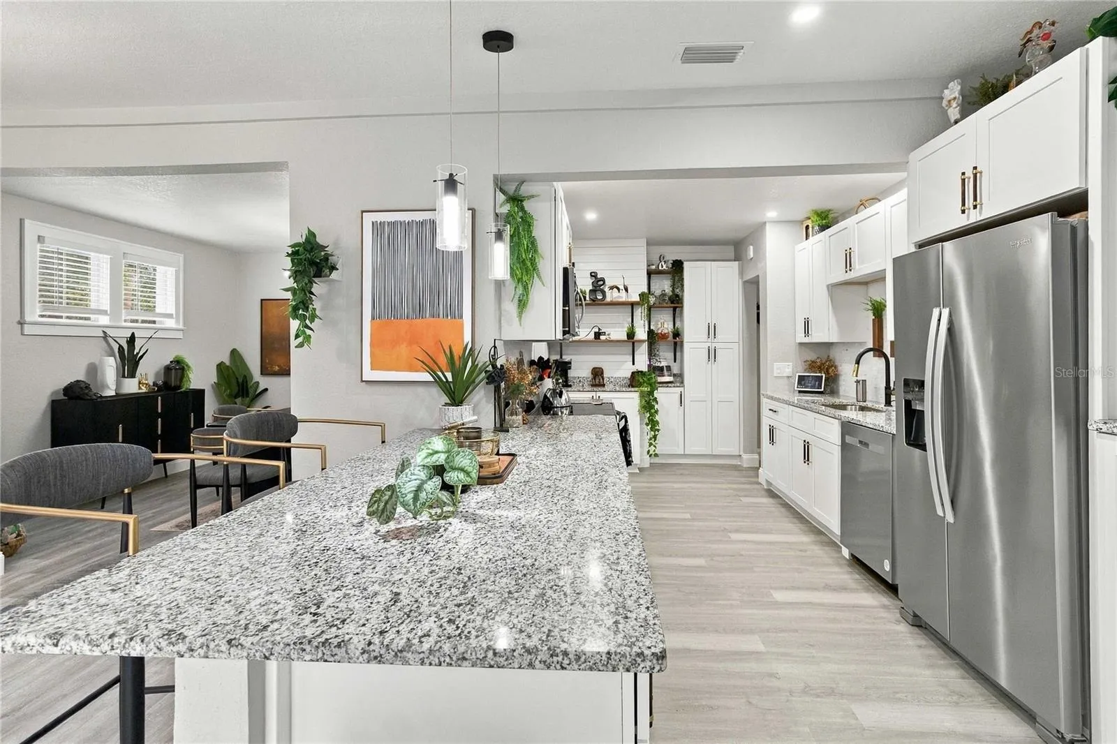 Kitchen with granite and stainless steel appliances.