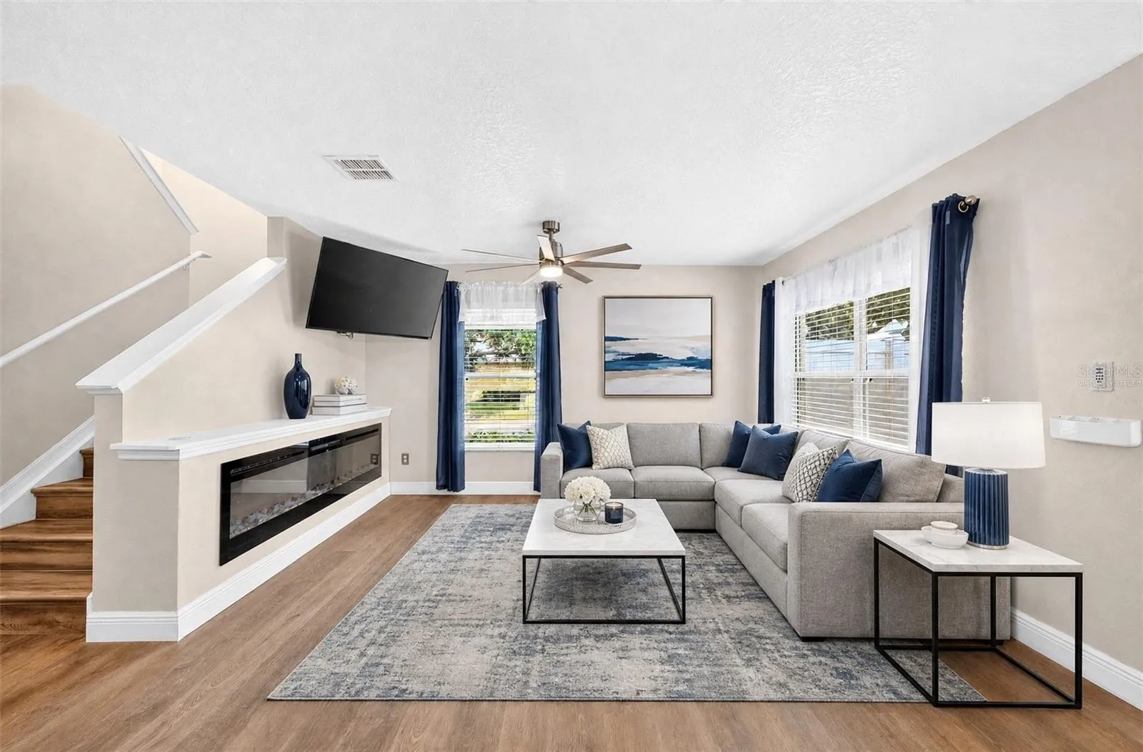 The Living Room makes a statement with its CUSTOM BUILT-IN ELECTRIC FIREPLACE (2025), adding warmth and ambiance to the space. Virtually Staged