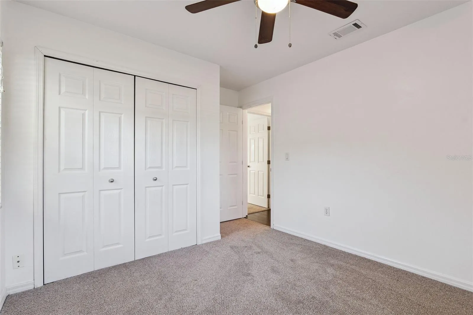 Comfortable bedroom with plush carpet