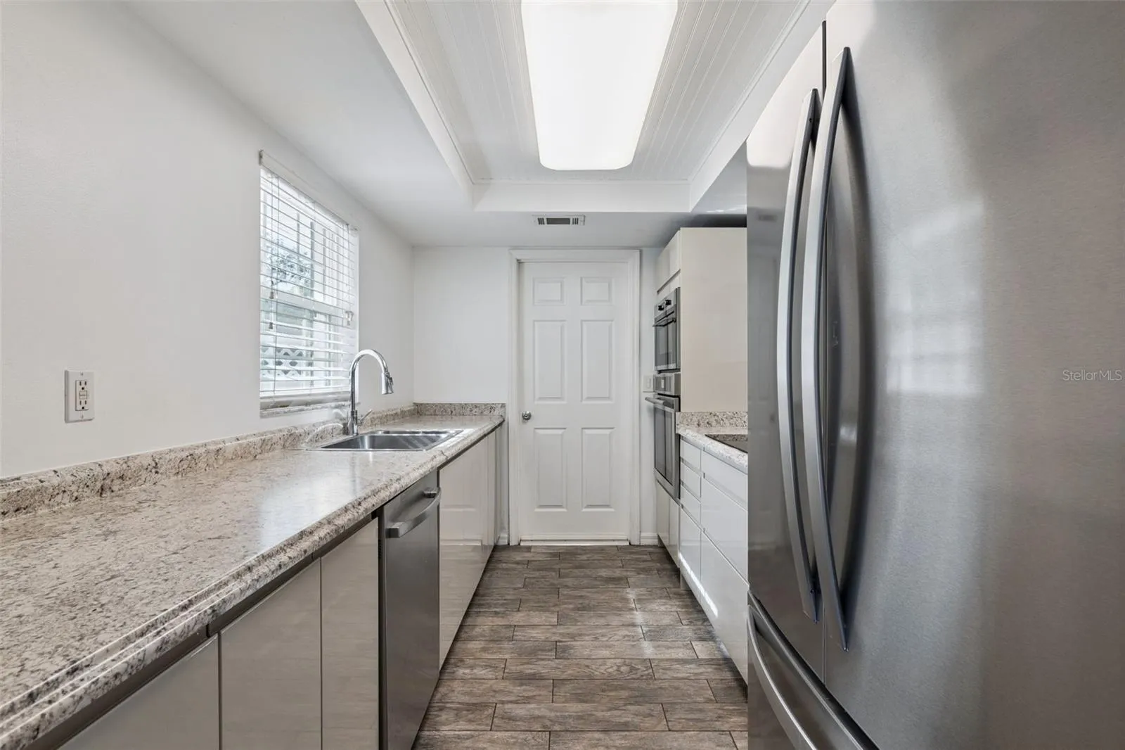 Lots of counter space, a stainless fridge and a window over the sink