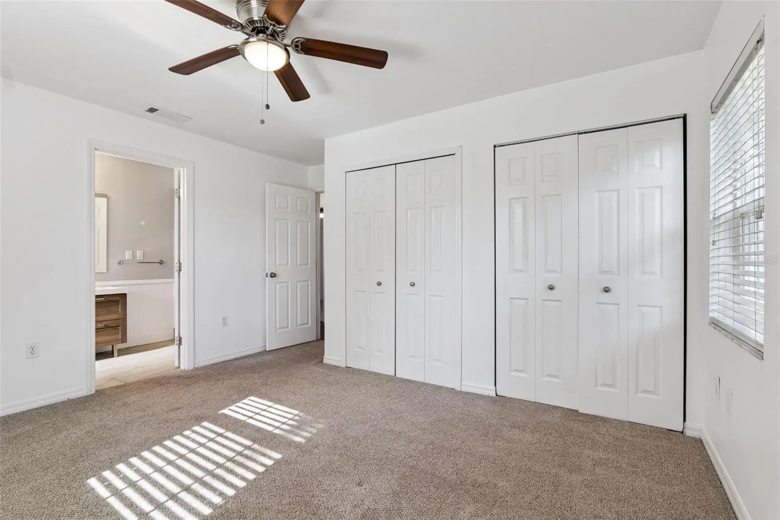 Primary bedroom with 2 closets and a private bath