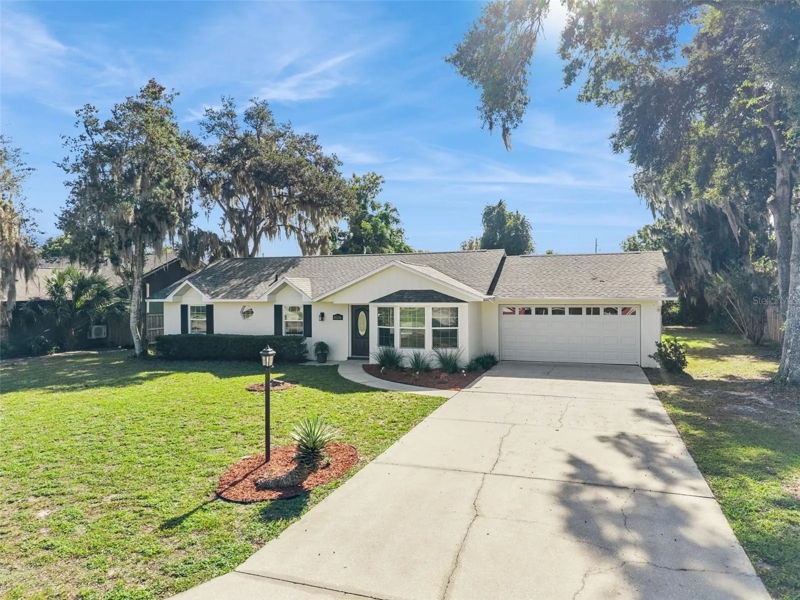 Two-car garage, wide driveway and fresh landscaping