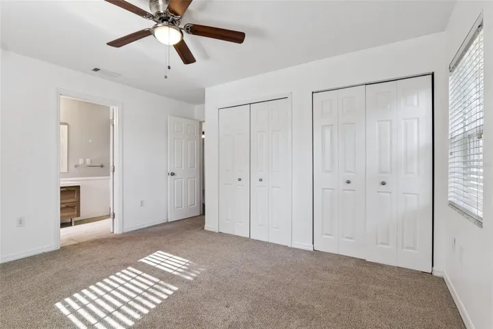 Primary bedroom with 2 closets and a private bath